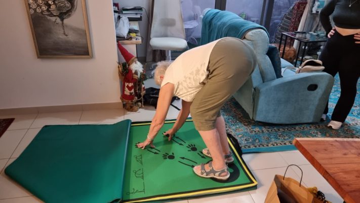 Photography of Louise's Mum bent over double using the Action Mat