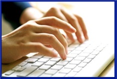 A picture showing someone typing on a white keyboard