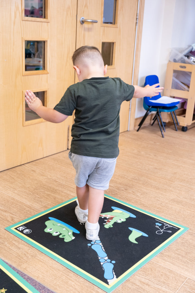 An image of a student standing on an Action Mat