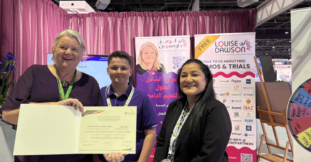 Louise Dawson and a colleague smiling holding the Certificate of Appreciation at the Louise Dawson Inclusion stand, celebrating the recognition for supporting educational inclusion.