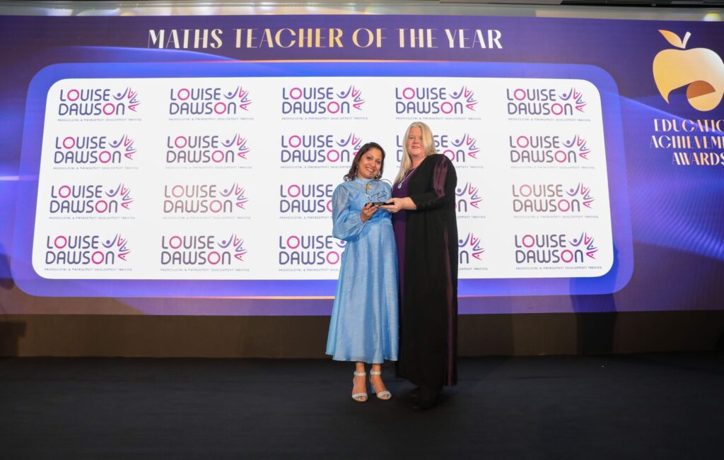 Louise Dawson, a judge, presenting the Maths Teacher of the Year award on stage at the Education Achievement Awards 2025 gala dinner.