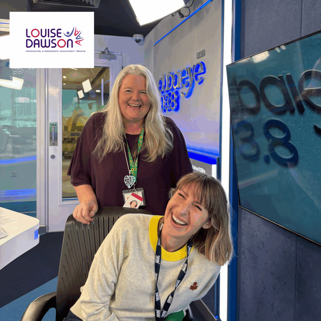 Louise Dawson laughing with Helen Farmer in the Dubai Eye 103.8 radio studio.